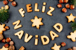 FELIZ NAVIDAD COOKIES. Words Merry Christmas en Spanish with baked cookies