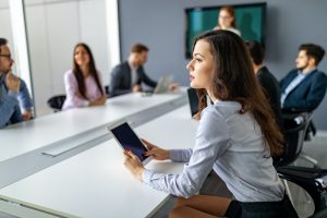 Business people having board meeting in modern office