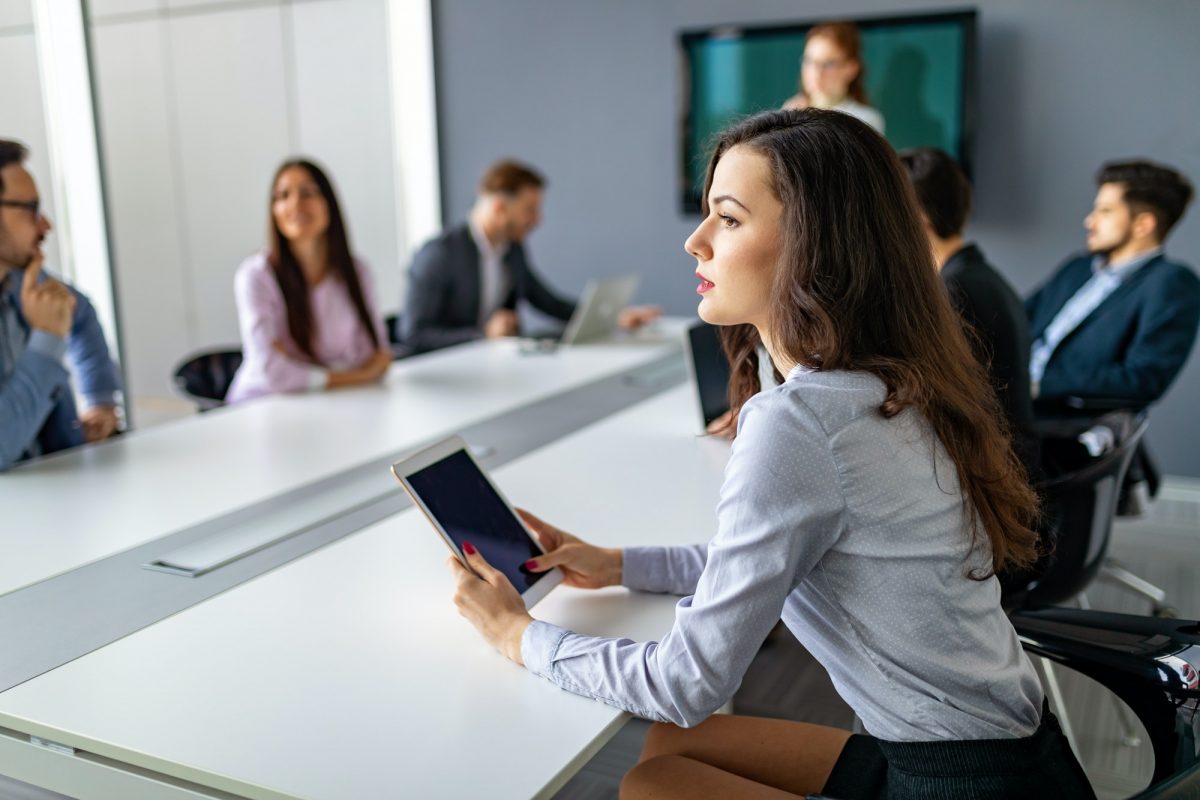 Business people having board meeting in modern office